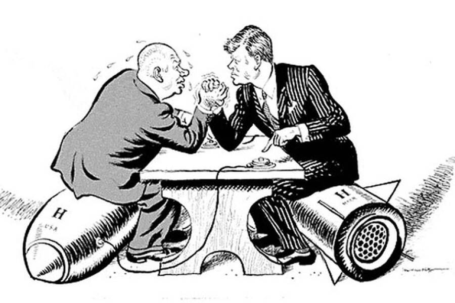 Карикатура, изображающая борющихся лидеров СССР и США, сидящих верхом на ядерных ракетах, которые подключены к «красным кнопкам»