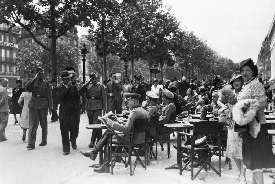 Немецкие солдаты приветствуют офицеров в кафе, Париж, июль 1940 года