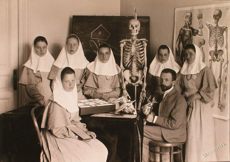 Врач проводит занятия по анатомии с группой сестер милосердия