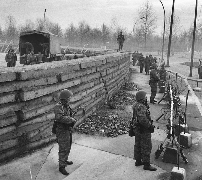 Солдаты Национальной народной армии ГДР охраняют участок границы с Западным Берлином, на котором идет строительство первой части Берлинской стены, 23 ноября 1961 года
